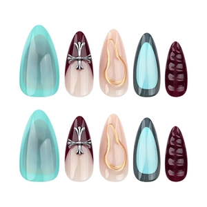 Short almond press-on nails with French cross charms and textured 3D knit patterns