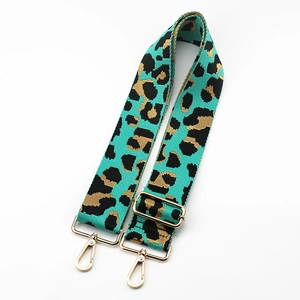 Detail of adjustable leopard jacquard bag strap with golden metal swivel lobster clasps
