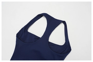 Detail of navy blue racerback yoga tank top showing smooth high-stretch fabric and flat seams
