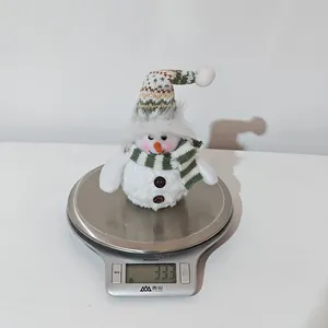 Detailed view of lightweight Christmas snowman plush weighing 33.3g on a scale