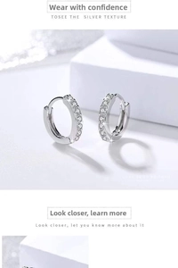 Macro shot of silver plated hoop earrings with shimmering cubic zirconia inlay details