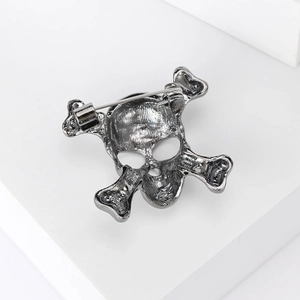 Macro view showing the back pin of the vintage skull and crossbones brooch