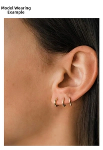Close-up of minimalist gold plated S925 sterling silver geometric hoop earrings worn by a model