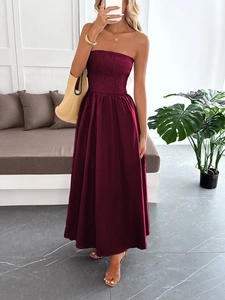 Detailed view of wine red smocked strapless maxi dress with a flowing skirt design