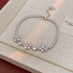 Macro shot of silver flower bracelet with sparkling cubic zirconia and S925 engraved tag