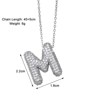Detail view of silver 'M' pendant with cubic zirconia and dimension measurements