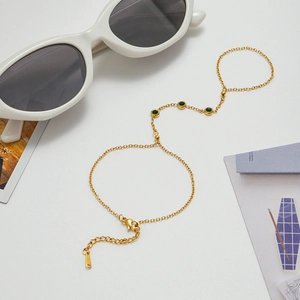 Detailed view of a gold-plated stainless steel bracelet with green zircon and lobster clasp