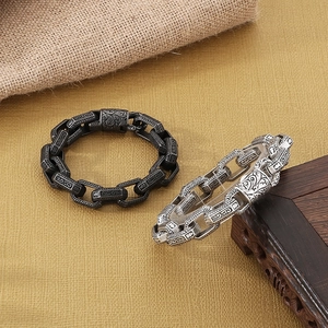 Macro view of vintage engraved rectangular chain links in antique silver and black finish