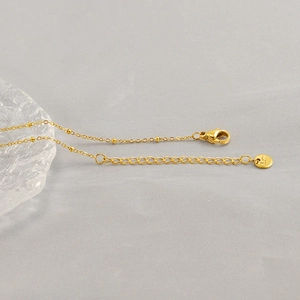 Golden starfish pendant necklace with adjustable chain and clasp on grey background