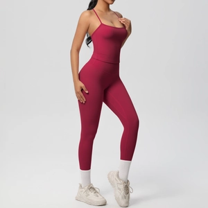 Detail of burgundy ribbed yoga set featuring thin straps top and high-waist compression leggings