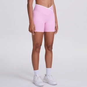 Detail of cross high waist yoga shorts with white trim in soft pink athletic fabric