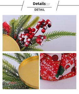 Detail of Christmas candle holder with red berries, pine needles and festive printed fabric
