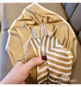 Detailed view of the striped silk scarf texture and elegant champagne satin fabric finish