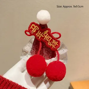 Detail of red festive hat hair clip with pom-poms and lace trim, size approx. 9x9.5cm