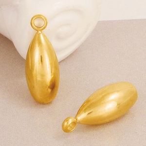 Macro detail of golden teardrop charms with top rings for DIY jewelry necklaces