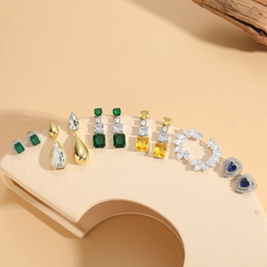 Detailed display of colorful gemstone earrings including teardrop and heart designs