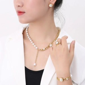 Detail showing Y-shaped gold chain necklace with pearls and clear gemstone jewelry set