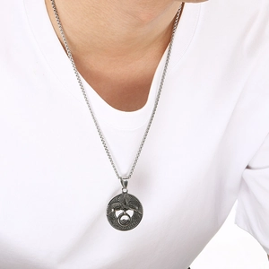 Detail of silver Celtic knot pendant with double-headed eagle on a woven chain necklace