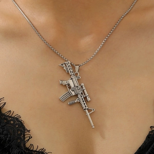 Detailed view of silver submachine gun pendant with vintage finish on link chain