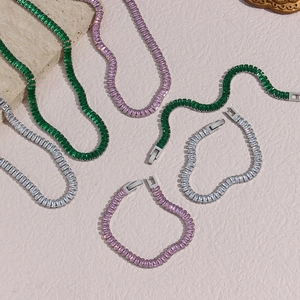 Detailed close-up of emerald and pink rectangle cut zircon necklace and bracelet set