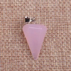 Close-up of pink crystal dowsing pendulum pendant on a textured burlap background
