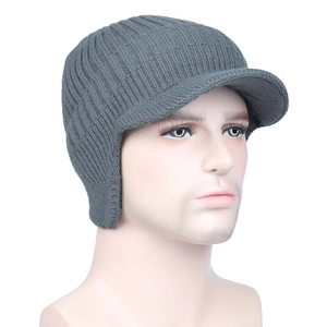 Detail view of a gray knit beanie with ear flaps and visor on a male mannequin head