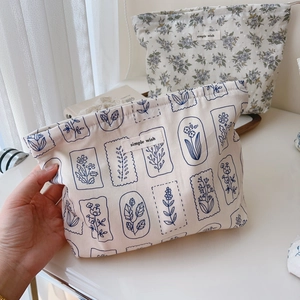Close-up of a floral cotton makeup bag with simple wish label and soft texture