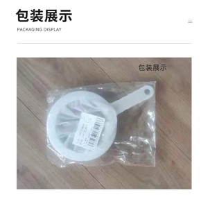 Fine mesh soy milk filter with handle in plastic packaging on a wood background