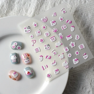 Macro detail of 5D cute rabbit nail stickers with embossed cupcake and star patterns