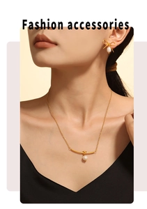 Detail of model wearing gold bow earrings and freshwater pearl necklace jewelry set