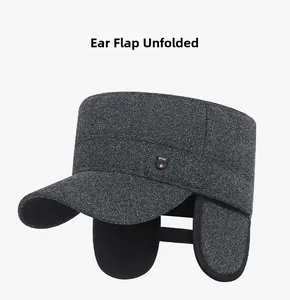 Detail of men's winter flat cap with earflaps down and sport label in dark grey melange