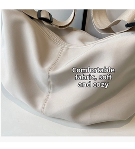 Detail shot of soft beige tote fabric showing fine texture and smooth side stitching