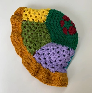 Top view of handmade crochet bucket hat with colorful patchwork and floral accents