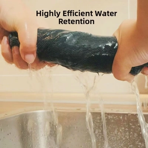 Close-up of hands wringing a highly absorbent blue microfiber cleaning towel to show water retention