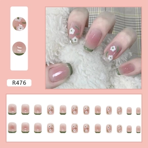 Short square press-on nails with pink-green gradient and delicate white floral patterns
