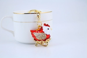Detailed view of red enamel rooster keychain with gold accents and sparkling crystals