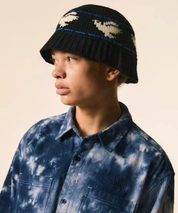 Detailed close-up of knit bucket hat with dove jacquard pattern and textured finish