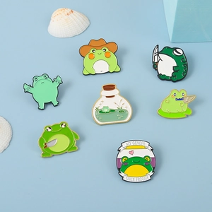 Set of 7 creative green frog enamel pins with cartoon animal designs and slogan badge