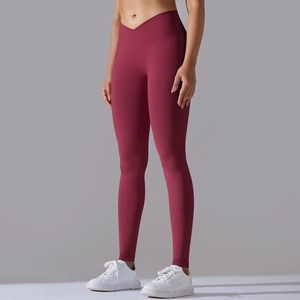 Close-up of seamless burgundy high-waisted yoga pants with a stylish cross V-waistband