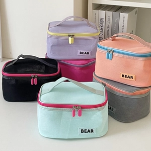 Detailed view of colorful mesh makeup bags with wide handles and resin zippers