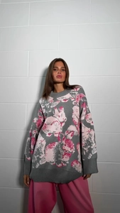Detail of pink rabbit jacquard on grey knit sweater showing fine texture and crew neck