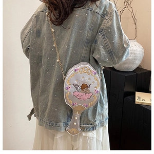 Detail view of baroque gray embroidery bag with pearl chain on a stylish outfit