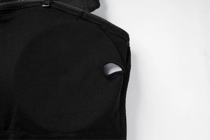 Macro detail of the internal breast pad slot on a black one-piece rhinestone swimsuit