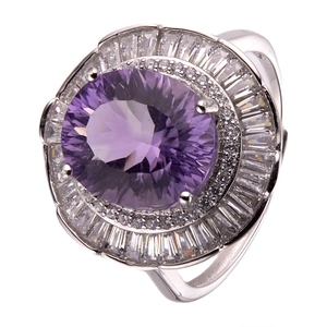 Macro shot of a large oval purple amethyst ring surrounded by shimmering pavé diamonds