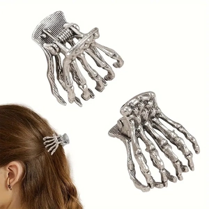 Silver gothic metal skull hand hair claw clip shown from multiple angles and on hair