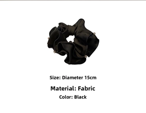 Detail view of 15cm large black silk scrunchie with rhinestones and soft fabric texture