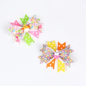Detail of Easter hair clips with printed ribbons featuring bunnies and chicks
