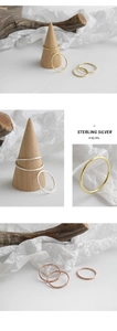 Detailed close-up of three minimalist S925 sterling silver rings in gold, silver, and rose gold
