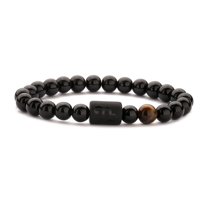 Scorpio zodiac stretch bracelet with black agate beads and tiger eye stone on white background