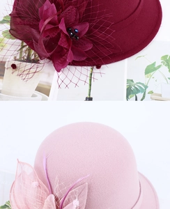 Detail of wool cloche hat showing gauze flower and feather accents in wine and pink